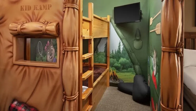 The bunk beds and TV inside the tent in the KidKamp Suite (Standard)